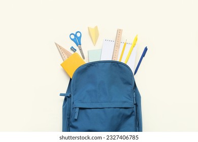 School backpack with paper plane and different stationery on light background - Powered by Shutterstock