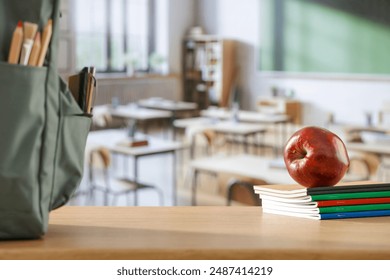 School backpack and school stuff with space for products on wooden desk in  classroom interior. Chalkboard wall background. Back to school. Copy space for school supplies and accessories. - Powered by Shutterstock