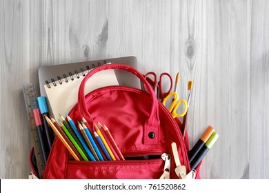 School Backpack And School Supplies On White Wood Table Background. Back To School Concept.