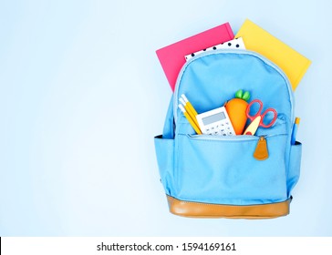 School Backpack,blue Bag  With Colorful Accessories Empty Space Background.