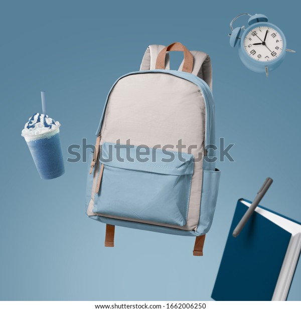School bag floating with school items advertising\
photography by
