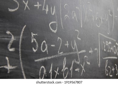 school board with formulas. scribbled in chalk chalkboard