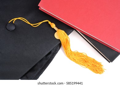 school books and graduation cap white background