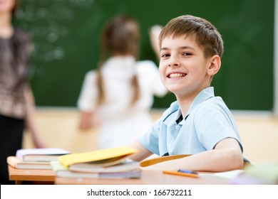 School boy in classroom at lesson