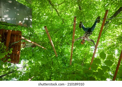 School Boy Climbing In Adventure Activity Park