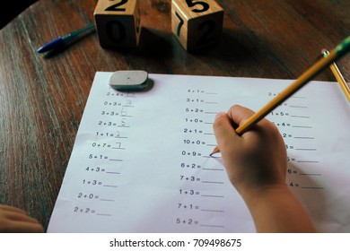 A school boy doing his first grade math homework. Concept for education.