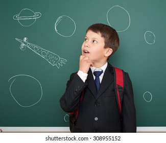 school boy with drawing space rocket on board - Powered by Shutterstock