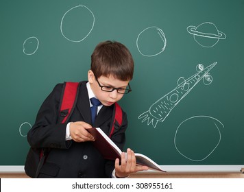 school boy with drawing space rocket on board - Powered by Shutterstock