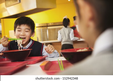 School Boy Eats Noodles In School Cafeteria