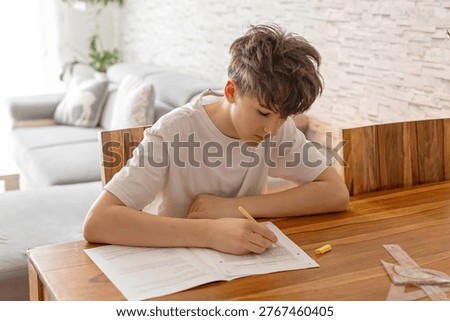 School boy, elementary school boy, preparing for exams for middle school at home, learning math and language