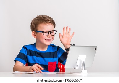 School boy having a video call on tablet computer. Zoom meeting. Domestic distance quarantine study safety. Modern confident boy in glasses and stylish clothes. - Powered by Shutterstock