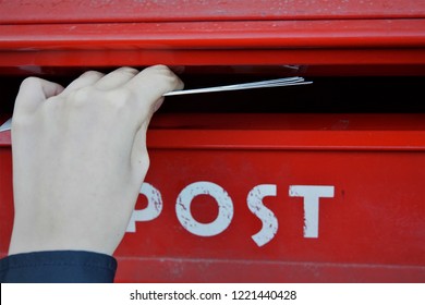 School Boy Sends Postcards. Postal service. Red And White Background.
