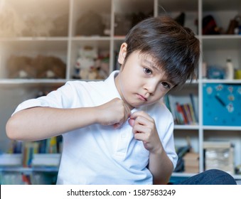 School Boy Sitting In Bed And Try To Wearing His Cloth With Bored Face, Unhappy Child Getting Dressed And Get Ready For School,, Kid Dressing Uniform In Bed Room Ready To School,Back To School Concept