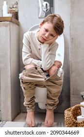 School Boy Is Sitting On Toilet With Suffering From Constipation Or Hemorrhoid. Caucasian Kid Is On Wc Seat, Bored And Tired, Have Rest Relaxed. Hygiene, Health Care Concept