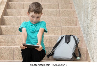 School Boy (student,pupil) Expresses Shock, Puzzle On His Face, Looking At Device Screen (cell Phone). Absence Of Parental Control,technology Addicted Kid Using Phone,obsessed With Mobile Social Media