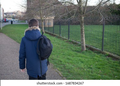 A School Boy Walking Home Outside His School In The UK