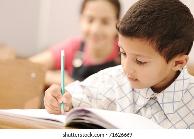 school boy is writing - Powered by Shutterstock