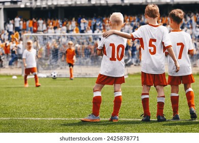 School Boys as Soccer Friends Teammates. Kids United in a Sports Team During Penalty Kick Game. Children in Football Uniforms at a Sports Arena Playing a Final Match. Young Players Supports Each Other - Powered by Shutterstock