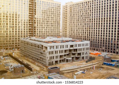 School Building Under Construction In Courtyard Of Apartment Buildings. Business Class Residential Complex Under Construction With School In Yard