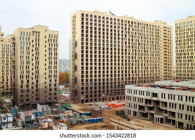 School Building Under Construction In Courtyard Of Apartment Buildings. Business Class Residential Complex Under Construction With School In Yard