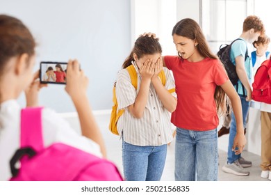 School bullying scene with teenage kids fighting in hallway with their classmate, taking video on smartphone camera. Stressed female victim student bullied by group of girls classmates in college. - Powered by Shutterstock