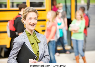 School Bus: Cheerful School Principal With Students In Background - Shutterstock ID 199611932