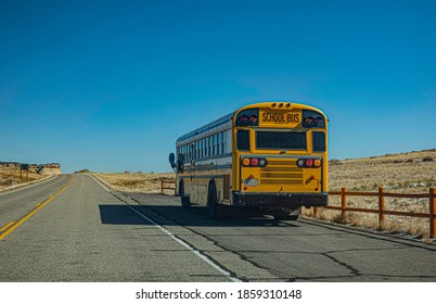 School bus on Utah desert road on blue sky background.  - Powered by Shutterstock