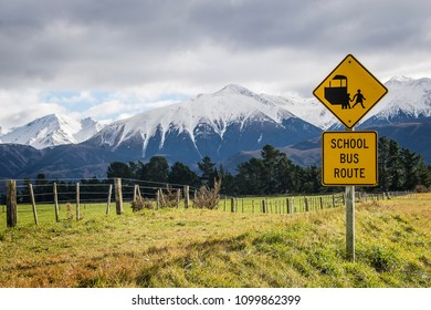 School Bus Sign Next To Winter Snowy Mountain Road