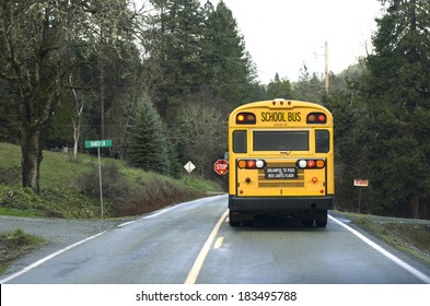 A School Bus Stops On A Rural Road To Let Off Students