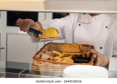 School Canteen Worker With Basket Of Bread At Serving Line, Closeup. Tasty Food