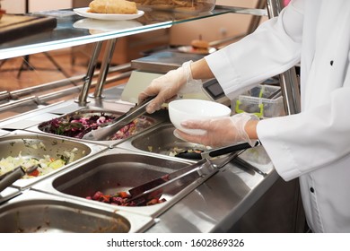 School Canteen Worker At Serving Line, Closeup. Tasty Food