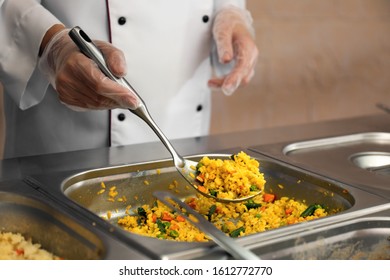 School Canteen Worker At Serving Line, Closeup. Tasty Food