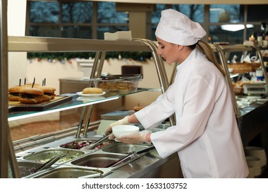 School Canteen Worker At Serving Line. Tasty Food