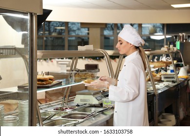 School Canteen Worker At Serving Line. Tasty Food