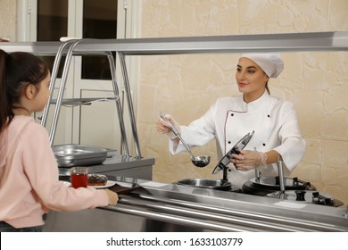 School Canteen Worker At Serving Line. Tasty Food