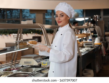 School Canteen Worker At Serving Line. Tasty Food