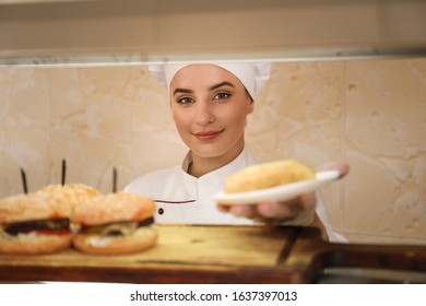 School Canteen Worker At Serving Line. Tasty Food