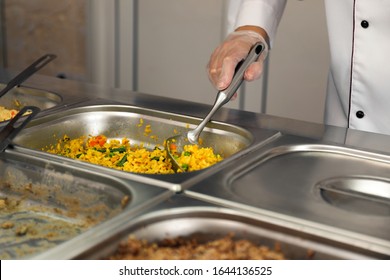 School Canteen Worker At Serving Line, Closeup. Tasty Food