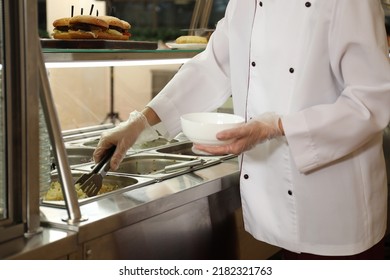 School Canteen Worker At Serving Line, Closeup. Tasty Food