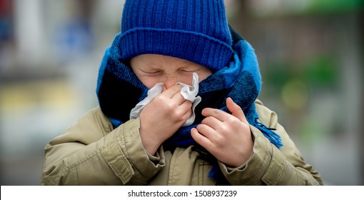 School Child Boy Blow His Nose. Sick Child With Napkin In Autumn Park. Allergic Kid, Flu Season. Kid With Cold Rhinitis, Get Cold. Back To School