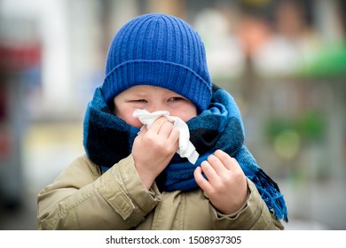 School Child Boy Blow His Nose. Sick Child With Napkin In Autumn Park. Allergic Kid, Flu Season. Kid With Cold Rhinitis, Get Cold. Back To School