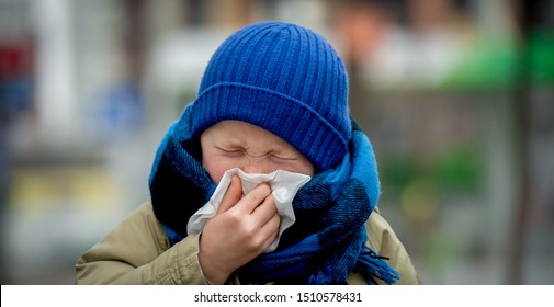 School Child Boy Blow His Nose. Sick Child With Napkin In Autumn Park. Allergic Kid, Flu Season. Kid With Cold Rhinitis, Get Cold. Back To School