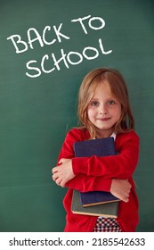 School child (girl) in classroom. Funny kid against green chalkboard. Idea and creativity concept. Copyspace on background. Back to school concept.  - Shutterstock ID 2185542633