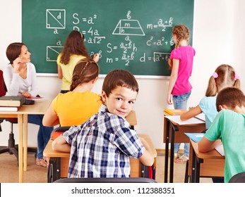 School Child With Teacher In Classroom.