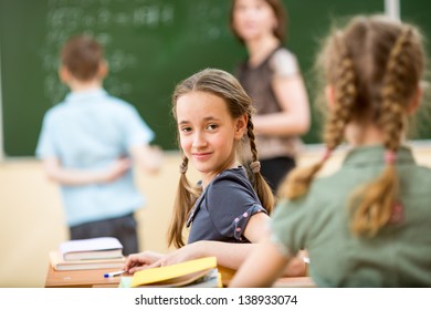 School children in classroom at lesson with teacher