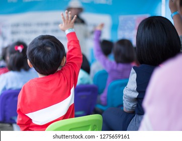 School Children In Classroom Raising Their Hand. Teacher Calling On Students. Teacher Teaching A Lesson In Class. Kids Go On A Field Trip. Question And Answer Session In Asian Elementary School. 