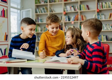 school children in the library reading books, doing homework, prepare a school project for lessons. High quality photo - Powered by Shutterstock