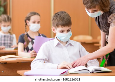 School Children With Protective Masks Against Coronavirus At Lesson In Class Room