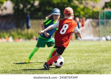  School Children Running Soccer Ball. Children Play Football Game on Sunny Day. Happy Kids Have Fun at Football Pitch - Powered by Shutterstock