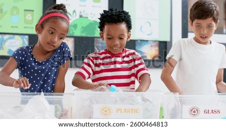 In school, children sorting plastic bottles into recycling bins, learning sustainability. environment, education, eco-friendly, waste management, kids, green living, unaltered, slow motion